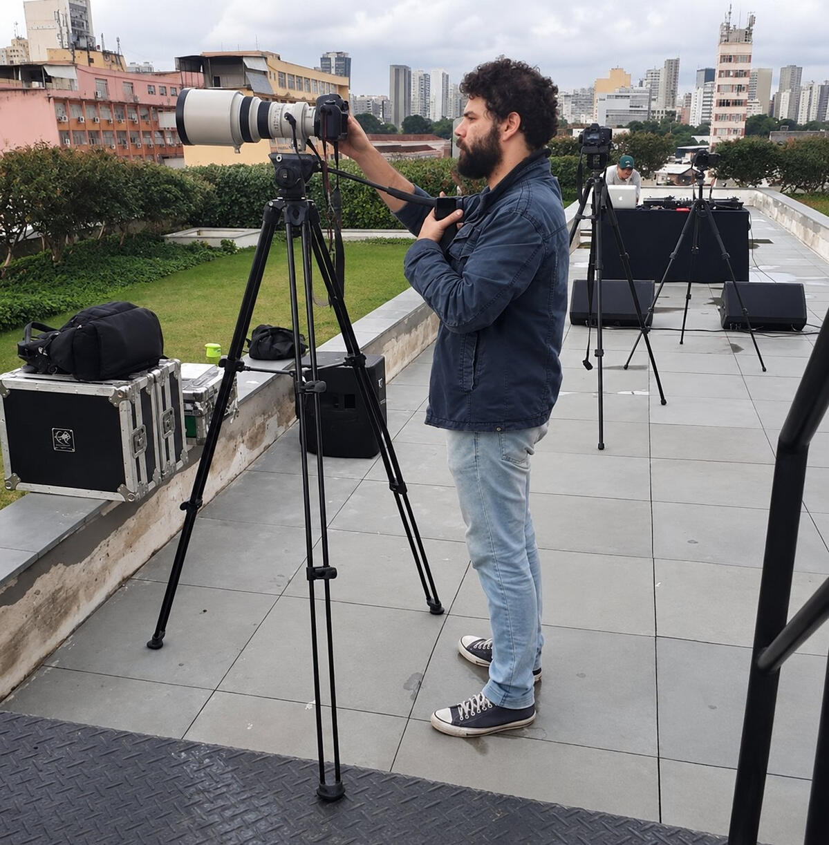 Hugo de Araujo em produção audiovisual Hugo de Araujo trabalhando com câmera durante uma produção audiovisual